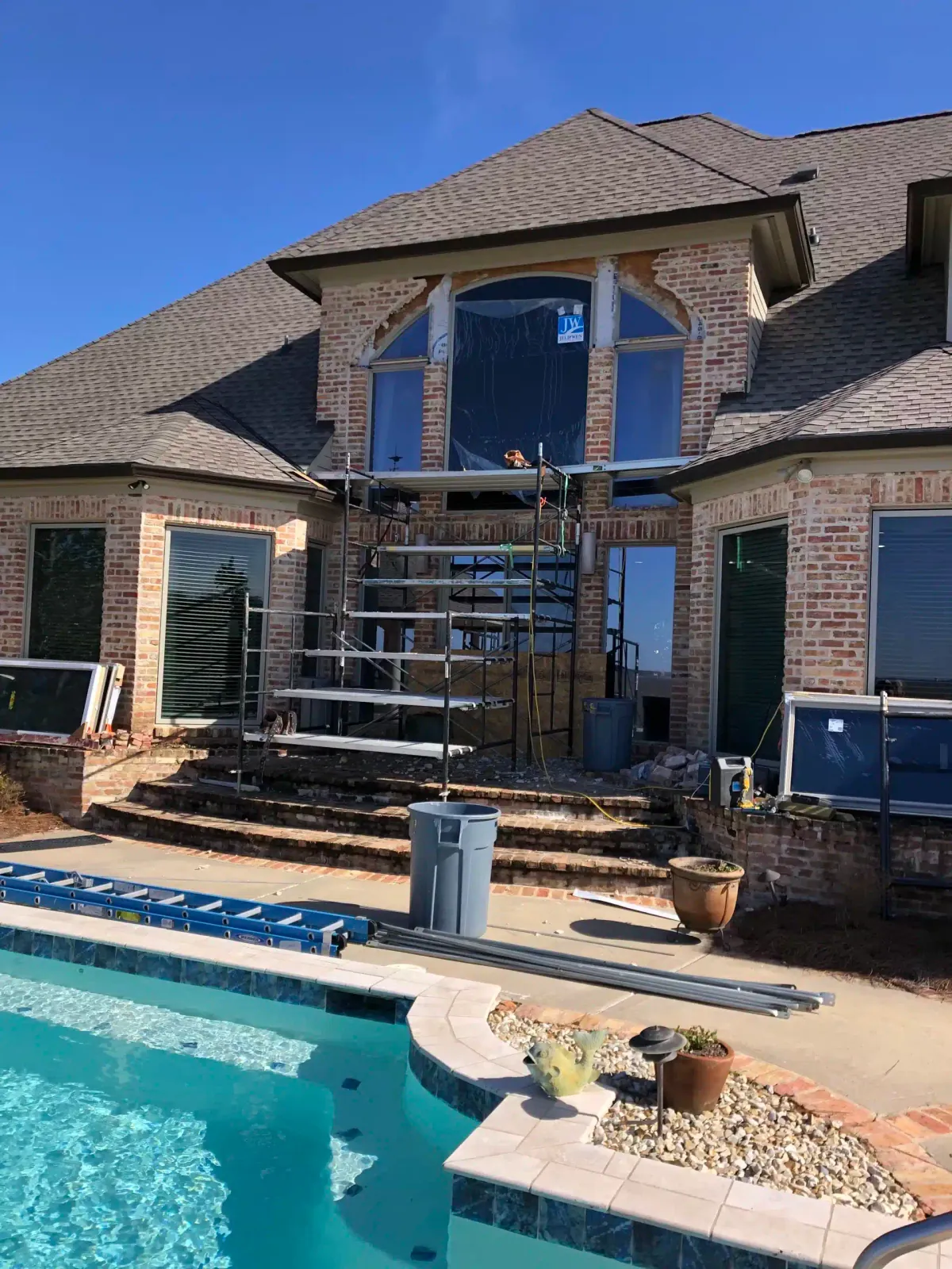 Scaffolding over the pool while the tall arched window is replaced