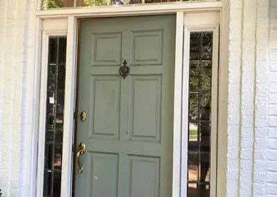 Old sage-green front door with sidelights before replacement